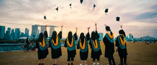 graduating students throwing hats in the air