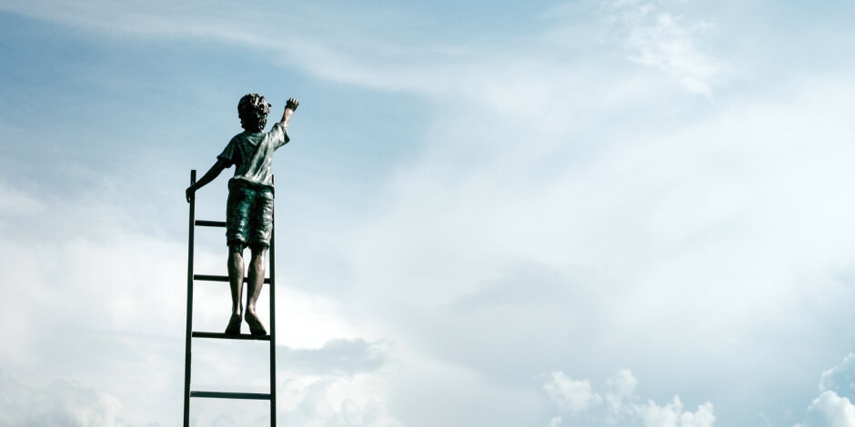 boy climbing ladder in sky