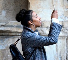Woman holding up and watching phone