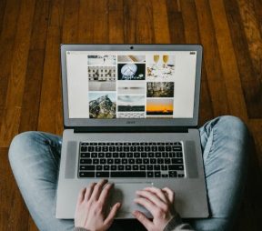 person working on laptop on the floor