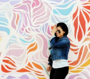 woman posing against art wall