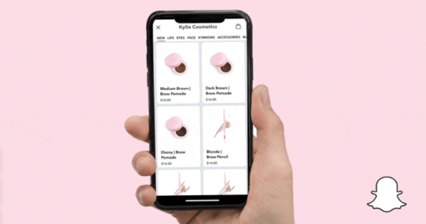 A hand holding a phone that shows what the Snapchat Native Store exclusive shopping experience is like.