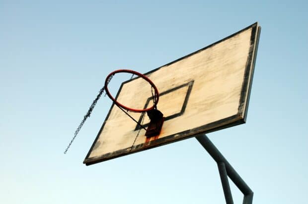 basketball net set on backdrop of blue sky