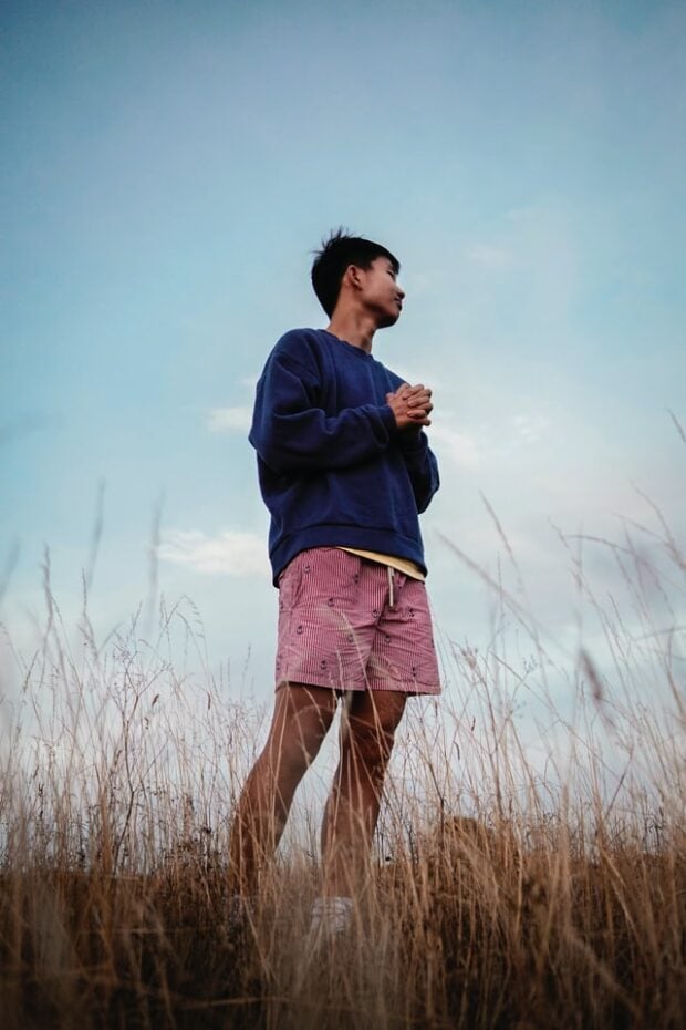 low angle show of person standing in a field