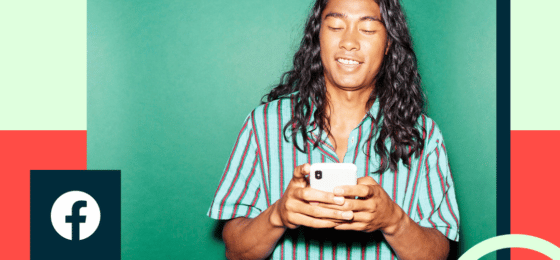 A person looks happily at their mobile device.