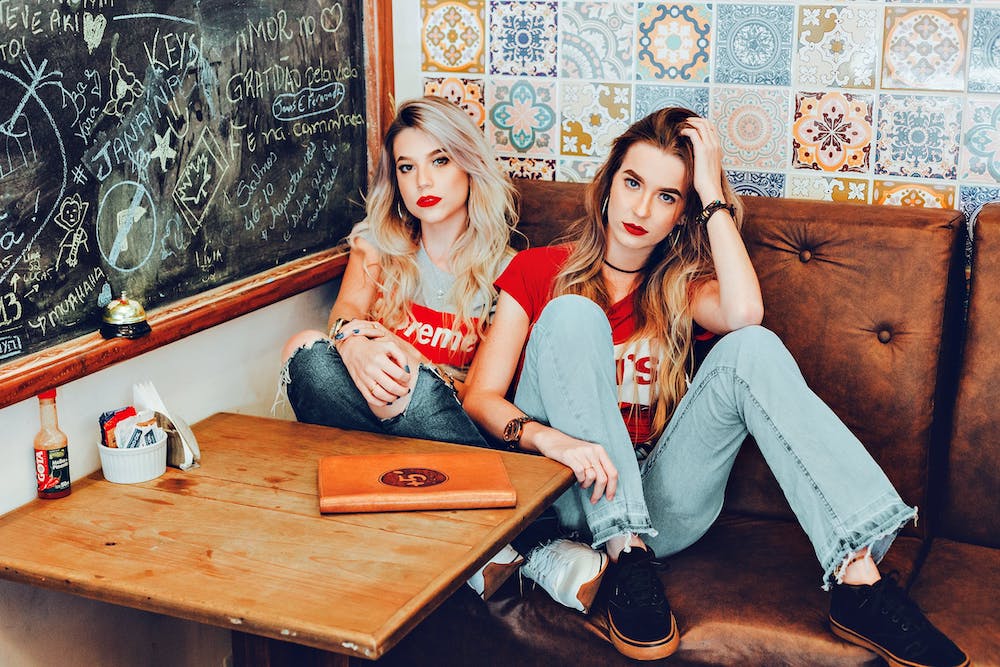 Two women sitting in a booth at a restaurant