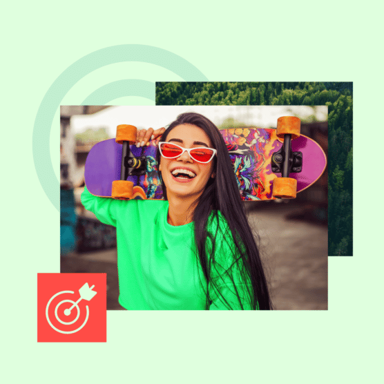 Woman smiles holding a skateboard behind her head.