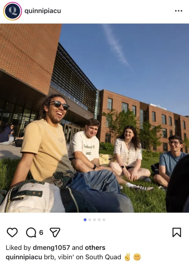 Example from Quinnipiac University showing students sitting outside on campus