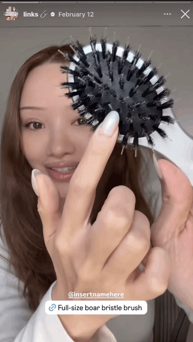 beauty influencer holding a hairbrush