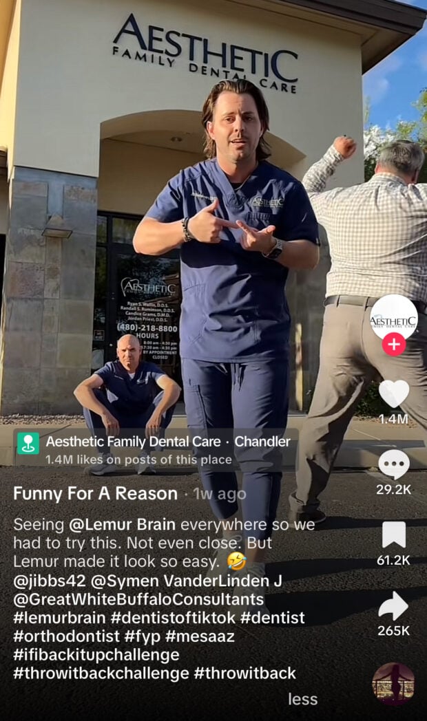 Three men outside Aesthetic Family Dental Care in Chandler mimic a dance trend. One gestures dramatically, another sits cross-legged, and a third faces away mid-move. On-screen text mentions the “Lemur Brain” challenge.
