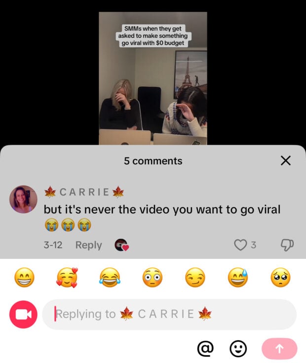 A TikTok reply interface shows the original video of two women laughing behind laptops with the caption “SMMs when they get asked to make something go viral with $0 budget.” The comment repeated below is “but it’s never the video you want to go viral 😭😭😭.”