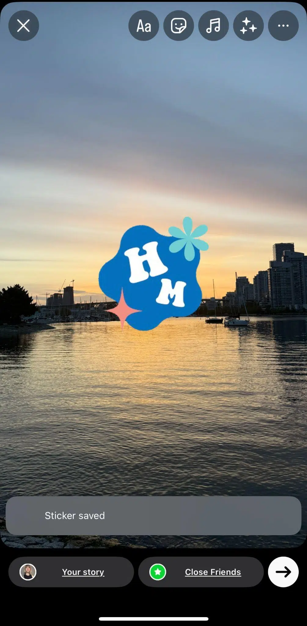 sunset with a blue and white logo overtop of it with the letters H and M in it